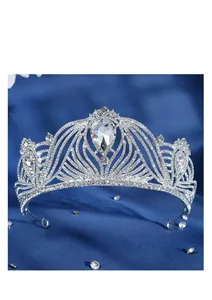 Close-up of silver bridal crown with intricate alloy filigree and water-drop rhinestone