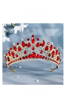 Close-up of golden bridal tiara with luxury red crystals and white rhinestones
