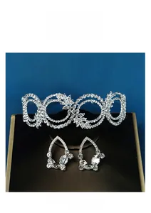 Detail of silver bridal jewelry set with crystal tiara headband and matching earrings