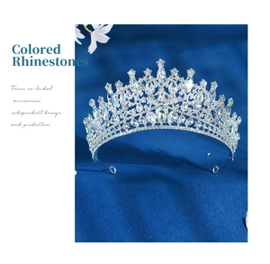 Detail view of a luxury silver bridal crown with blue sapphire rhinestones on blue silk