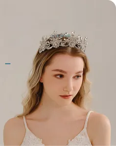 Detailed view of vintage silver bridal crown with intricate floral rhinestones on model