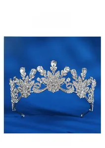 Detail of silver bridal crown with floral crystal patterns on dark blue silk background