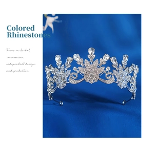 Detailed macro view of vintage silver bridal crown with intricate floral rhinestone patterns