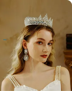 Side view of luxury silver bridal crown with AB rhinestones and matching earrings