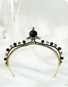 Close-up detail of vintage gold bridal crown with black beads and sparkling crystals