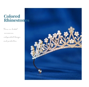 Macro detail of bridal crown with gold plating, white pearls, and clear rhinestones