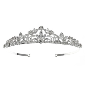 Detailed view of a silver bridal tiara with sparkling rhinestones and ornate scroll patterns