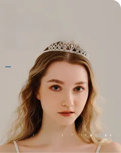 Detailed close-up of a sparkling rhinestone bridal crown comb on a model's hair