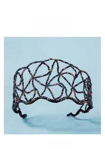 Detailed close-up of dark iridescent beads hand-woven into a luxury bridal headband