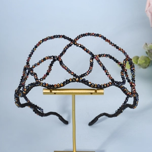 Macro detail of handmade iridescent rhinestone headband with woven luxury AB crystal beads
