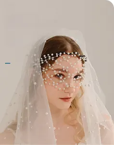 Detailed view of hand-woven pearl mesh veil and long bridal tulle for wedding party wear