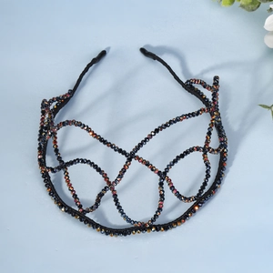 Detailed close-up of handmade black beaded headband with colorful AB rhinestone finish