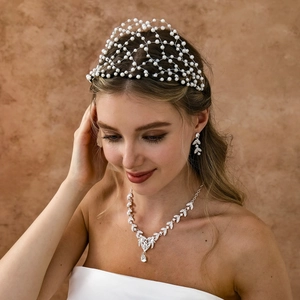 Close-up of vintage bridal hairpiece with white pearls and silver diamond jewelry set