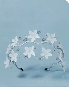 Detailed macro view of handmade crystal bridal headband with white matte flowers