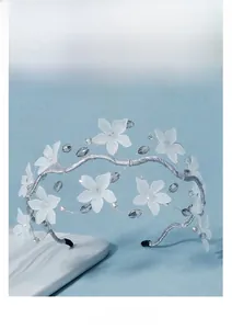 Detail of bridal headband with frosted white flowers and crystal beads on silver wire