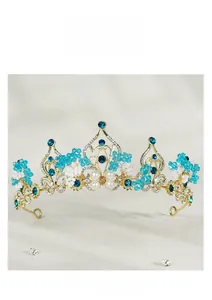 Close-up of golden bridal crown with blue crystals and intricate filigree details