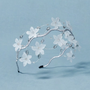 Elegant white floral bridal headband with crystals and silver wire for wedding hair styling