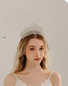 Detailed view of silver wedding crown with teardrop rhinestones on a bridal model