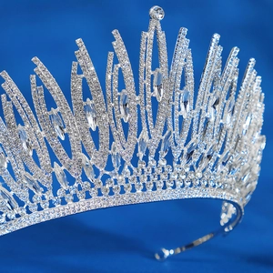 Luxurious silver bridal crown with marquise-cut crystals on a deep blue background