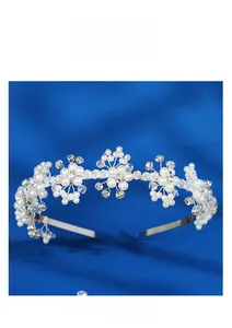 Detailed macro view of bridal flower tiara with white pearls and clear crystals