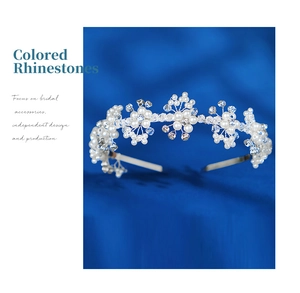 Detailed macro view of handmade bridal headband with white pearls and blue crystals