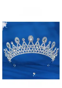 Detailed macro view of the silver bridal crown with crystals on dark blue silk fabric