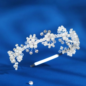 Exquisite bridal headband with white pearls and crystals on a silver frame