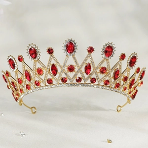 Luxurious bridal tiara crown with red crystal gemstones and shimmering rhinestones