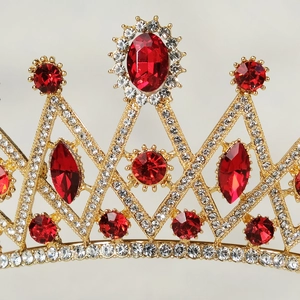 Luxurious gold crystal bridal crown with red gemstones and white rhinestones