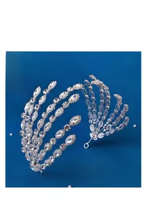 Macro detail of luxury silver bridal crown with shimmering crystals on blue background