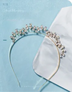 Macro detail of a double-layered gold rhinestone headband with floral crystal patterns