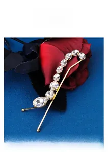 Detailed close-up of a bridal hair clip featuring ten sparkling oval rhinestones on gold