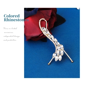 Detail of a vintage golden hair clip with radiant white marquise rhinestones on silk