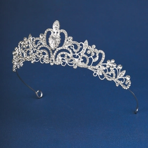 Close-up of silver bridal tiara with floral rhinestone patterns and a drop-shaped gemstone