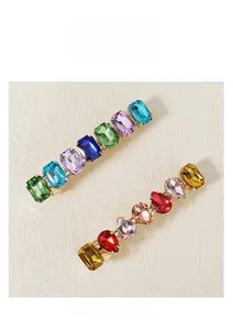 Detail view of colorful crystal hair clips with gold alloy base for bridal weddings