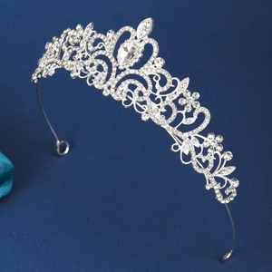 Detailed side view of a vintage silver bridal crown with intricate sparkling rhinestones
