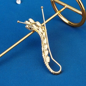 Elegant gold-plated wavy ear cuff featuring sparkling crystals and a sleek streamline design