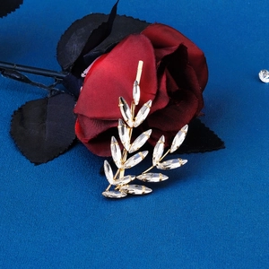 Detail view of the golden leaf hair clip featuring sparkling marquise rhinestones and alloy base