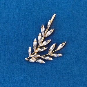 Detailed view of a gold leaf hair pin featuring sparkling marquise-cut crystal rhinestones