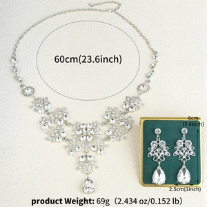 Macro detail of bridal jewelry set with crystal teardrops and size measurements