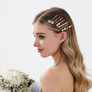 Close-up of model wearing luxury hairpins with colorful rhinestones on gold metal base