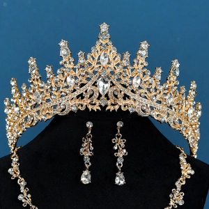 Detailed view of luxury gold bridal jewelry set with sparkling rhinestones on velvet