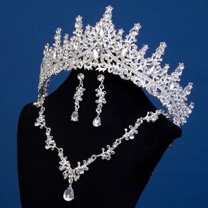 Detailed view of silver bridal jewelry set with sparkling rhinestones on black stand