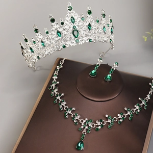 Macro detail of bridal jewelry set with green crystals on a premium brown display stand
