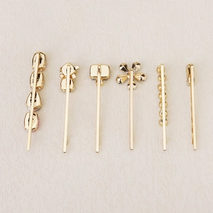 Detailed set of six gold-plated hair clips featuring floral and geometric designs
