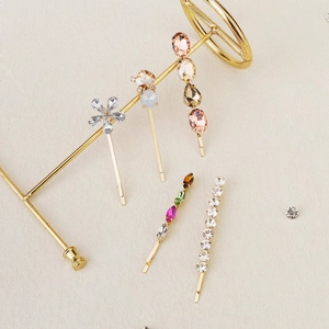 Detailed macro view of 5-piece gold hair clip set with colorful rhinestones and crystals