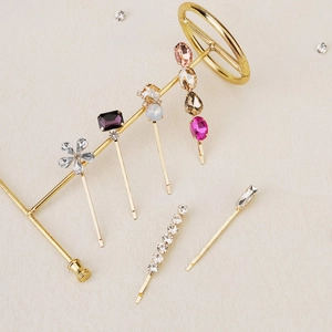 Colorful rhinestone hair clip set with floral and geometric designs on gold metal frames