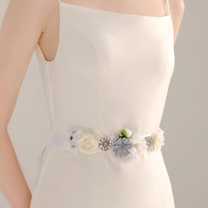 Elegant handmade bridal belt with fabric flowers and sparkling crystals on white satin ribbon