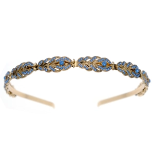 Detailed view of the gold alloy headband with intricate blue rhinestone leaf patterns
