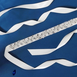 Detail of bridal sash with marquise rhinestones and pearls on white satin ribbon